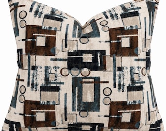 May include: A square throw pillow featuring a geometric pattern of dark brown, navy blue, and light beige rectangles, squares, and circles. The design is printed on a textured fabric with a repeating arrangement of shapes and lines across the surface.