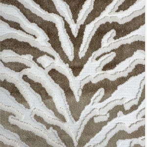 May include: A white and brown zebra print rug with a textured, fluffy surface.