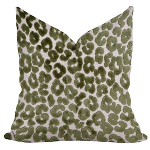May include: A square cushion featuring a green leopard print design on a cream-coloured backdrop. The cushion has a soft, textured feel, and the animal print is evenly spread across the surface.