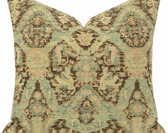 May include: A square throw pillow featuring a textured fabric with a repeating diamond-shaped pattern in shades of dark brown, sage green, and soft cream. The intricate design consists of ornate, symmetrical motifs within each diamond shape.