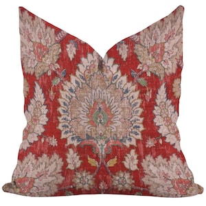 May include: Decorative throw pillow with a distressed red background and a large, ornate floral pattern in beige, blue, and green. The pillow has a vintage, antique aesthetic, perfect for adding a touch of elegance to any room.