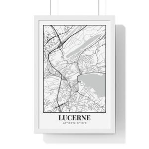 May include: A framed black and white map print of Lucerne, Switzerland. The map shows the city's roads, waterways, and surrounding areas. The city name and coordinates are printed at the bottom of the print.