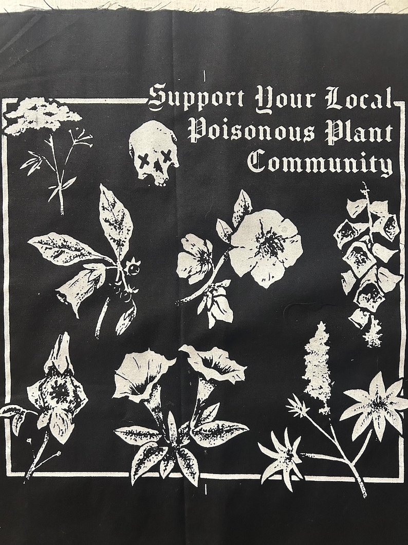 May include: Black and white graphic featuring various plant illustrations and a skull. The text reads "Support Your Local Poisonous Plant Community" in a gothic font. The design is framed by a white border.