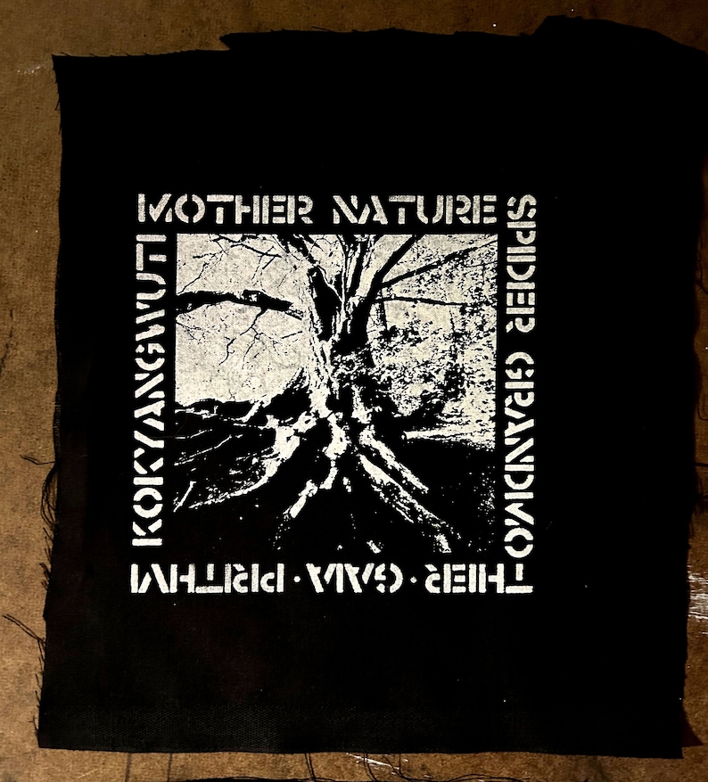 May include: Black and white patch with the text "MOTHER NATURE'S SPIDIER GRANDMOTHER", "THEIR WAVES", and "KOKYANGWUT" surrounding a black and white image of a tree with roots.