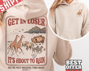 May include: Beige hoodie with a graphic on the back that says "GET IN LOSER IT'S ABOUT TO RAIN" with illustrations of giraffes, elephants, zebras, and Noah's Ark. The front of the hoodie has a small giraffe graphic. The text "WE'RE NOT MISSING THIS BOAT GENESIS 6-9" is also included.
