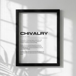 May include: A framed print with the definition of "CHIVALRY" in bold black text. The definition is on a white background, and the frame is black. The print includes the pronunciation and a description of chivalry.