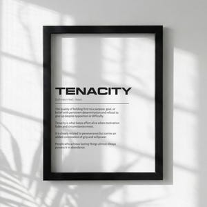 May include: A framed print with the word "TENACITY" in bold, black letters. Below the word is a definition of tenacity. The frame is black, and the background is white. The print is a motivational piece.