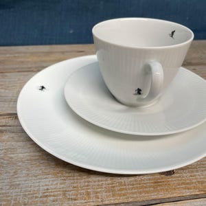 Skier mugs & plates, snow white with handcrafted screen-printed appliqués;