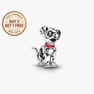 May include: A silver-colored Dalmatian puppy charm with black spots and a red collar. The puppy is sitting, with its tail curled. The charm has a glossy finish and is set against a white background.