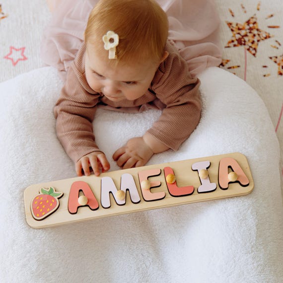 A hand-cut wooden name puzzle where each letter doubles as a chunky grab toy — a genuinely tactile, personalized keepsake that's both Montessori-useful and display-worthy in a nursery.