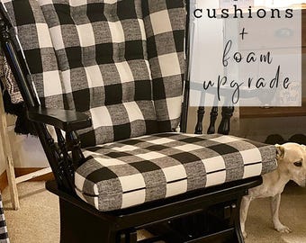 May include: Black and white buffalo check wingback glider cushions with a foam upgrade. The glider is black and has a wooden frame.