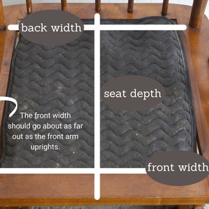 May include: A close-up of a wooden rocking chair with a black fabric seat cushion. The image shows the measurements for the back width, seat depth, and front width of the chair.