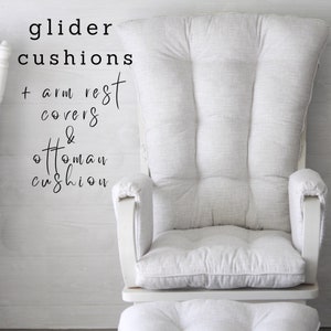 May include: White glider cushions with armrest covers and ottoman cushion. The cushions are made of a soft, textured fabric.