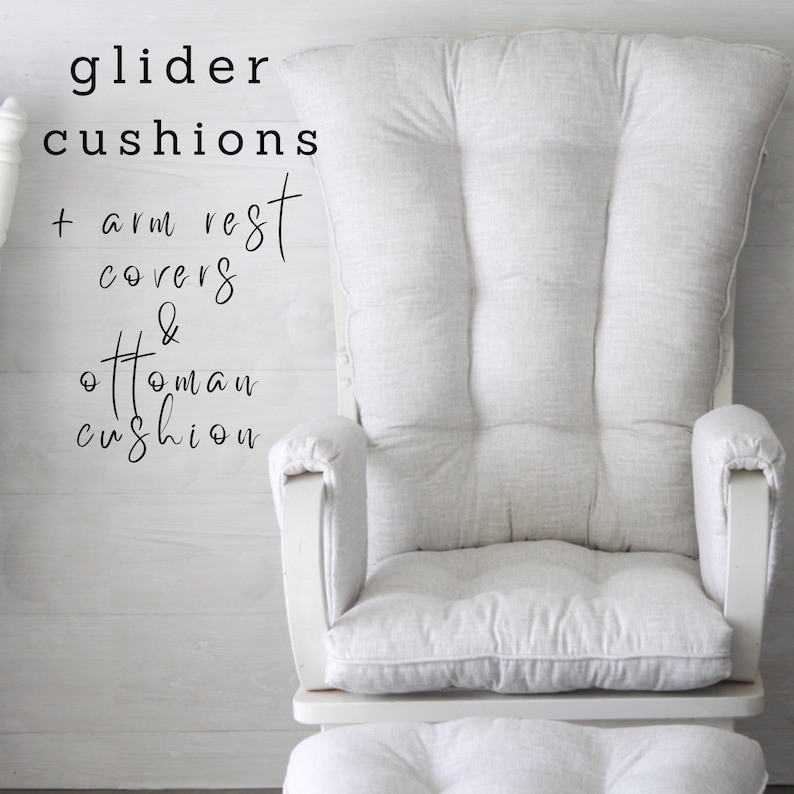 May include: White glider cushions with armrest covers and ottoman cushion. The cushions are made of a soft, textured fabric.