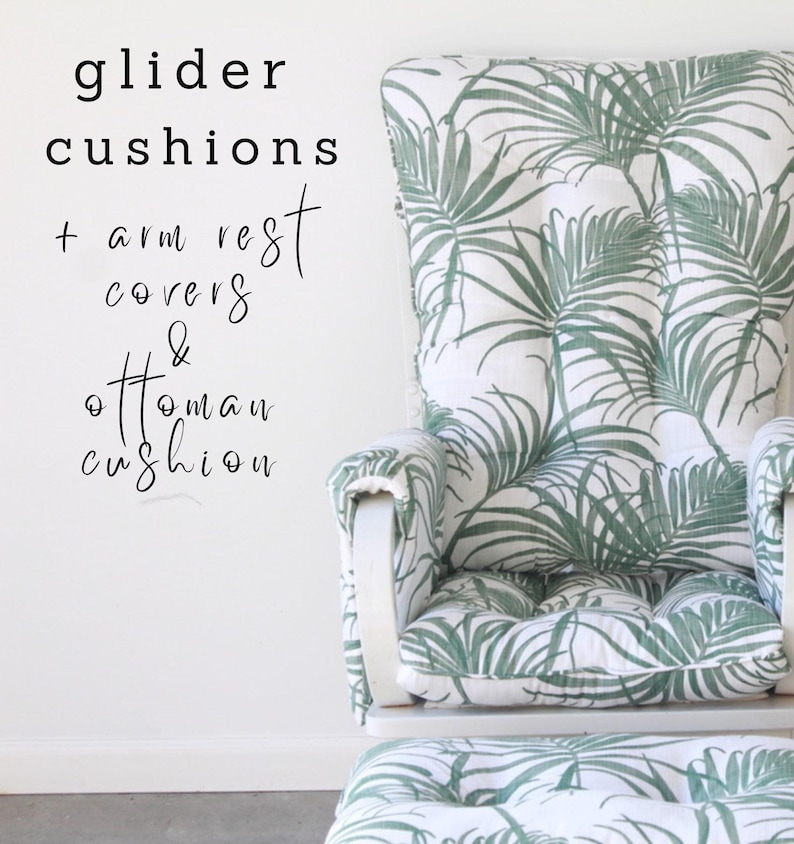 May include: White glider chair with green tropical leaf patterned cushions and a matching ottoman. The text "glider cushions + arm rest covers & ottoman cushion" is written in black on a white wall.