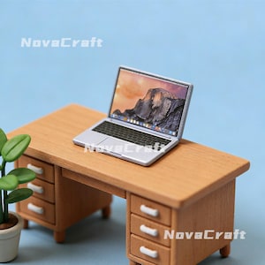 May include: Miniature wooden desk with a silver laptop displaying a mountain landscape. The desk has three drawers on each side and a light brown finish. The text "NovaCraft" is visible.