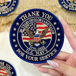 May include: A navy blue embroidered patch with the text "THANK YOU" and "FOR YOUR SERVICE". The patch features an American flag design with an eagle and the text "250 YEARS OF GLORY AND VALOR" and "U.S. NAVY 1775-2025".