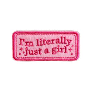 May include: A pink embroidered patch with the text "I'm literally just a girl" in a darker pink font. The patch has a rectangular shape with a stitched border and star accents.