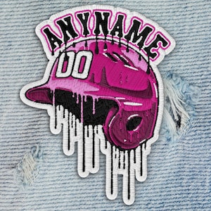 May include: Embroidered patch featuring a pink baseball helmet with the text "ANYNAME" above and "00" on the helmet. The design includes black dripping accents and a white border, set against a denim background.