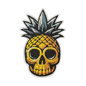 May include: Embroidered patch featuring a yellow pineapple skull design with black eye sockets and a jaw. The pineapple has a spiky, green and blue crown. The patch is outlined with a white border.