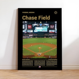May include: A black framed poster featuring Chase Field in Phoenix, Arizona. The poster includes a photograph of the baseball field, the stadium name in gold, and text at the bottom. A baseball graphic is at the top right.