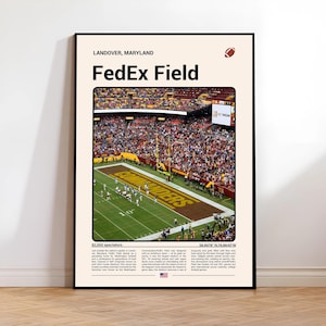 May include: A framed poster featuring FedEx Field in Landover, Maryland. The image shows a football game in progress, with a packed stadium and the word "Commanders" visible on the field. The poster includes text with the stadium's name, location, and details.