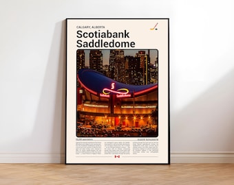 May include: A framed poster featuring the Scotiabank Saddledome in Calgary, Alberta, at night. The arena is illuminated with red and yellow lights, with the text "Scotiabank Saddledome" prominently displayed. The poster includes additional text and a hockey stick icon.