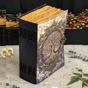 May include: A leather-bound journal with a detailed tree of life design on the cover. The cover features a purple and gold color scheme with an ornate border and a metal clasp. The pages have a vintage, aged appearance.