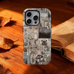May include: A phone case with a collage design featuring vintage botanical illustrations, a butterfly, a miniature painting, and a typewriter. The case has a glossy finish and a dark border. The background is a wooden surface with a book.