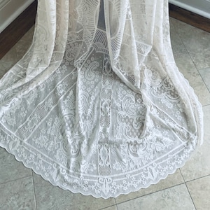 hemline photo of an intricate lace bohemian long wedding dress on Etsy