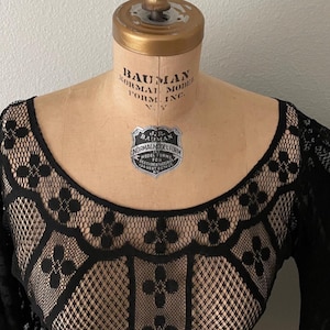 Close-up of the neck line for this sheer black Bohemian Bell sleeve dress