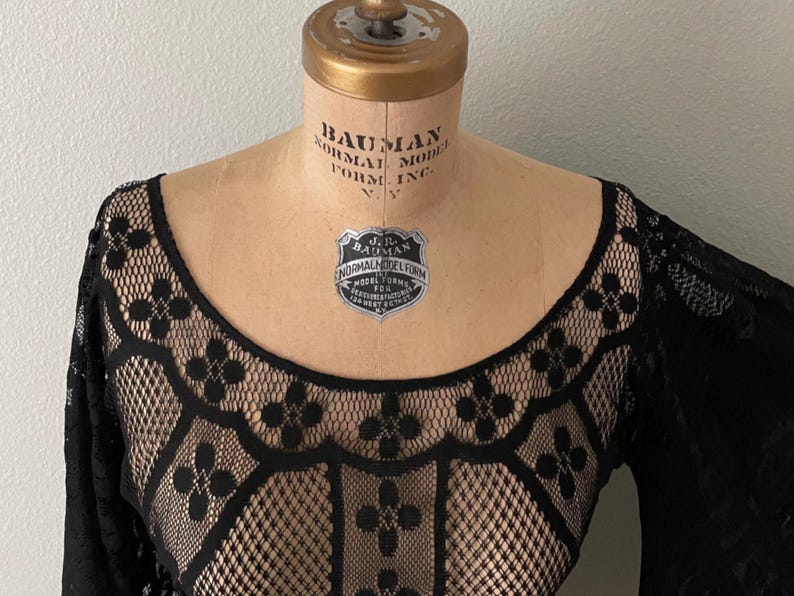 Close-up of the neck line for this sheer black Bohemian Bell sleeve dress