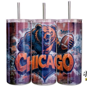 May include: A stainless steel tumbler with a design of a bear holding a football, and the word "CHICAGO" in orange. The background is graffiti-style, with a stainless steel straw.