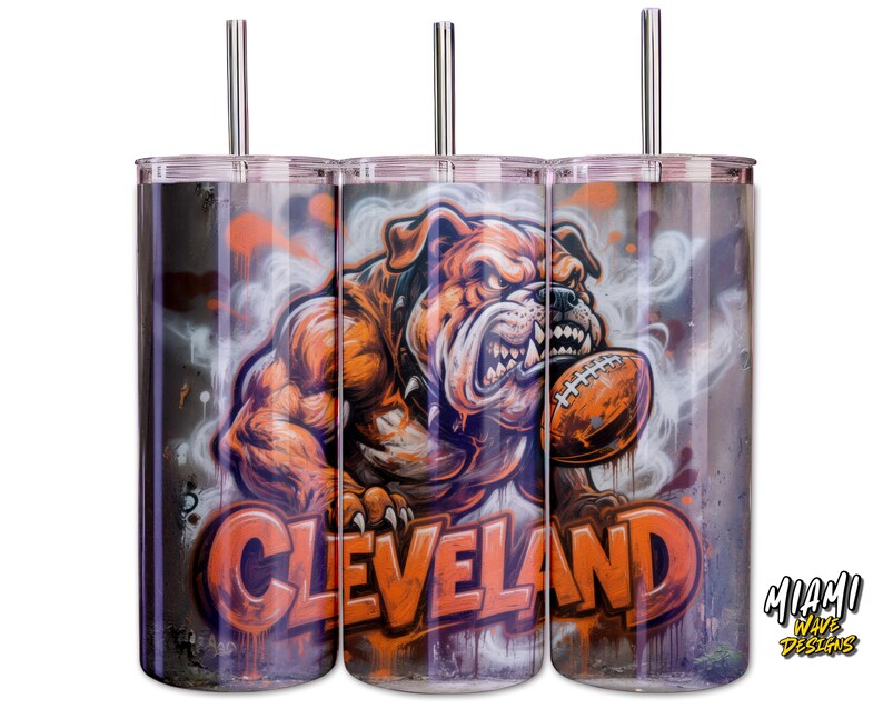May include: Three stainless steel tumblers with lids and straws. Each tumbler has a muscular bulldog graphic holding a football, with the word "Cleveland" in orange. The background has a graffiti-style design.