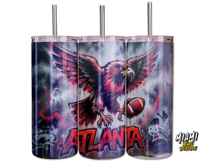 May include: Three stainless steel tumblers with lids and straws. Each tumbler features a design of a red and black eagle holding a football, with the word "ATLANTA" in red. The background has a graffiti-style design.