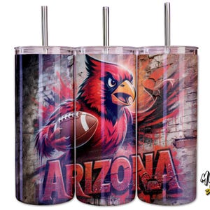 May include: Three stainless steel tumblers featuring a red cardinal bird holding a football, set against a brick wall background. The word "ARIZONA" is displayed in red graffiti-style lettering. Each tumbler has a silver straw.
