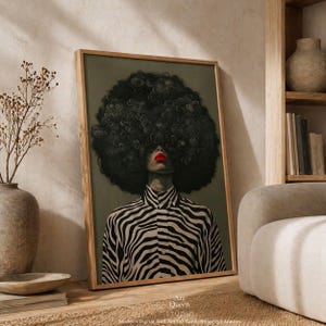 May include: Framed art print featuring a woman with a large, dark afro and red lipstick. She wears a black and white zebra-striped shirt. The artwork is labeled "Art Queen Studio."