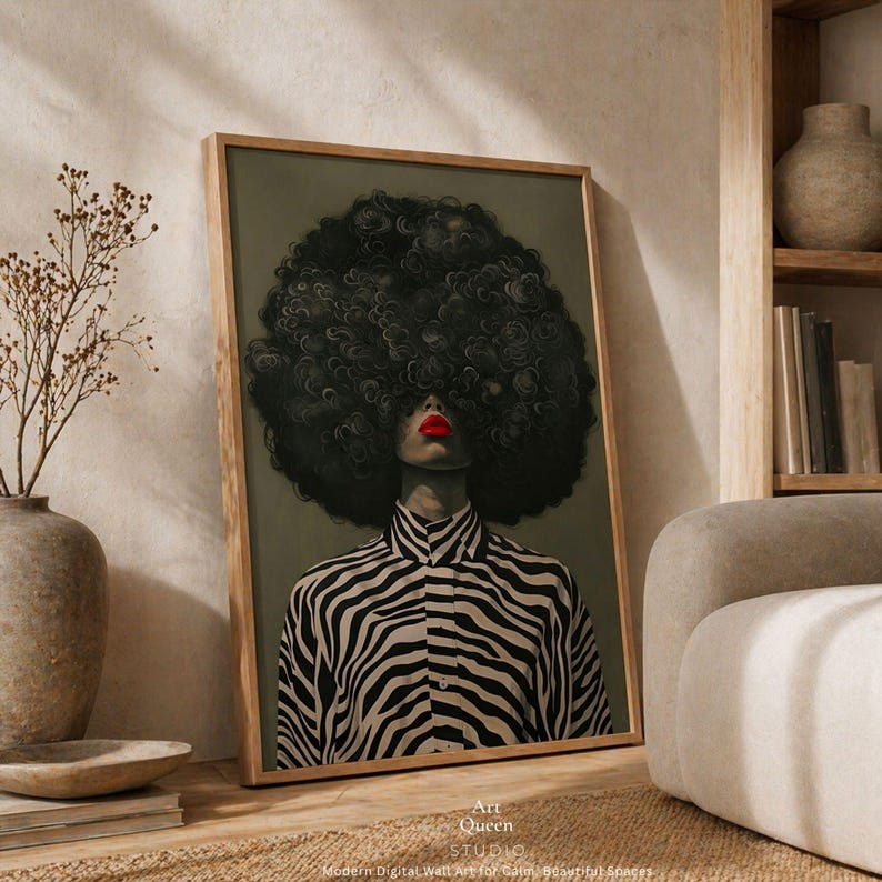 May include: Framed art print featuring a woman with a large, dark afro and red lipstick. She wears a black and white zebra-striped shirt. The artwork is labeled "Art Queen Studio."