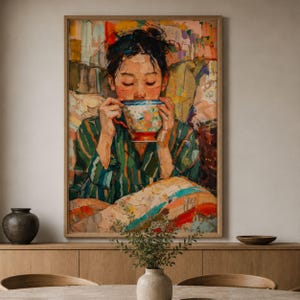 May include: A framed art print depicts a person enjoying a beverage from a colorful teacup. The artwork features a person in a green striped robe, with a vibrant, impressionistic style. The color palette includes greens, oranges, and blues.