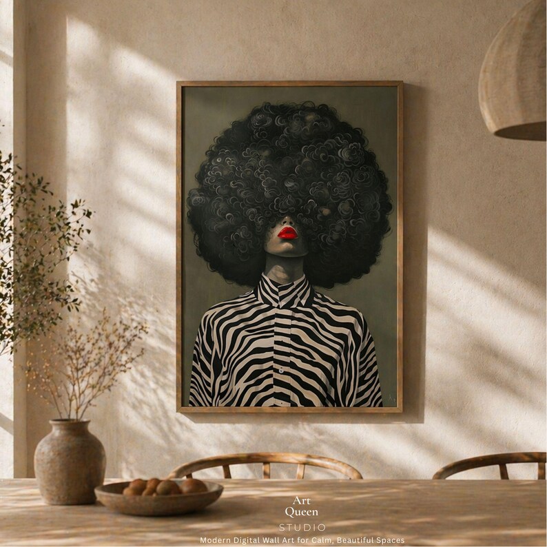 May include: A framed art print featuring a person with a large, dark, curly afro and red lipstick. The person is wearing a black and white zebra-striped shirt. The print is labeled "Art Queen Studio" with text below that reads "Modern Digital Wall Art for Calm, Beautiful Spaces."