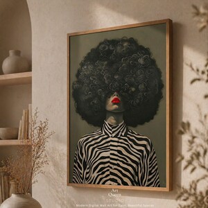 May include: A framed art print featuring a woman with a large, curly afro and bold red lipstick. She wears a black and white zebra-striped collared shirt. The artwork is set against a muted green background. The text "Art Queen Studio" is at the bottom.
