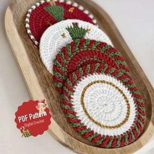 Peut inclure: Sous-verres de Noël crochetés rouges, blancs et verts, disposés sur un plateau en bois. Les sous-verres présentent un motif circulaire avec des accents dorés et un motif festif. L'image comprend le texte "PDF Pattern Digital Crochet".