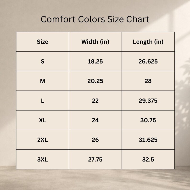 Może przedstawiać: Tabela rozmiar&oacute;w Comfort Colors, pokazująca rozmiary od S do 3XL. Tabela zawiera wymiary szerokości i długości w calach. Szerokości wahają się od 46,36 cm (S) do 70,49 cm (3XL).