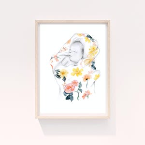 May include: Watercolor art print of a sleeping baby wrapped in a floral blanket. The blanket features yellow, orange, and pink flowers with green leaves. The artwork is framed in a light wood frame.