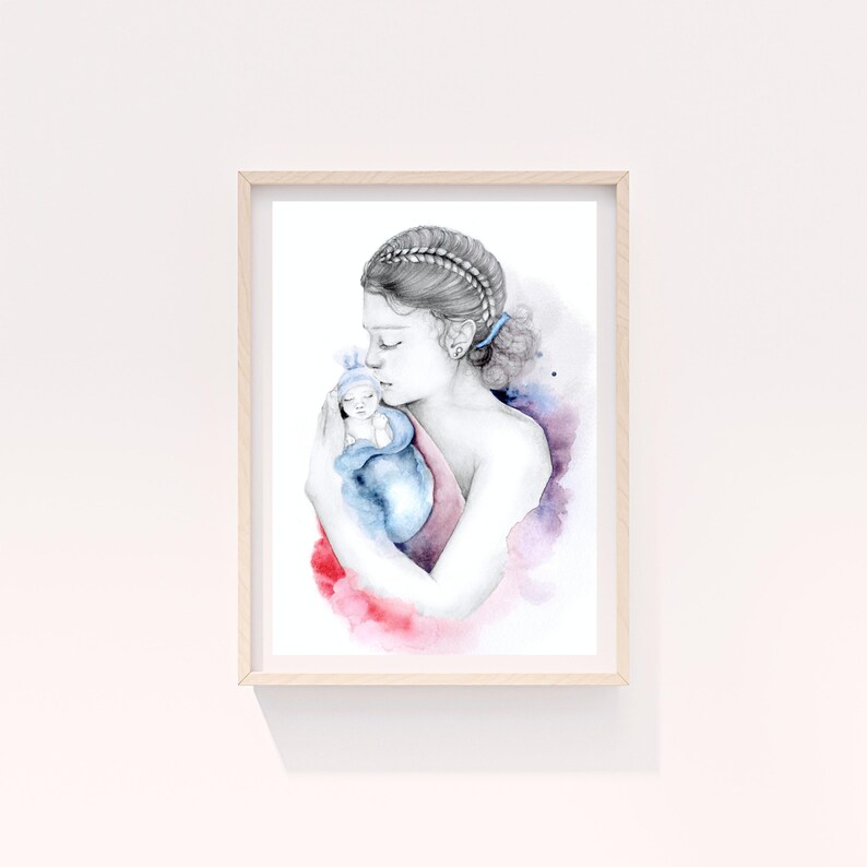 May include: Watercolor print of a mother cradling a baby, framed in light wood. The artwork features soft watercolor washes of red, blue, and purple. The mother's hair is styled in braids, and the baby is wrapped in a blue blanket.