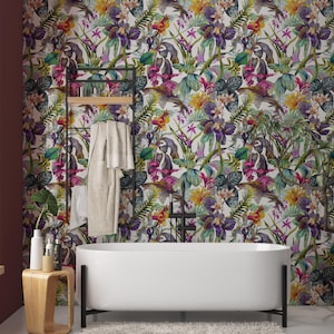 May include: A modern bathroom with a white bathtub and a floral wallpaper featuring colorful flowers and birds. A wooden side table holds toiletries. A black metal ladder holds a robe and towels.