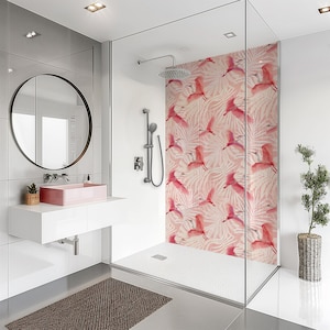 May include: Modern bathroom with a glass shower enclosure featuring a pink bird and leaf pattern. The room includes a round mirror, a pink sink, and a brown rug. The shower has a rain shower head.