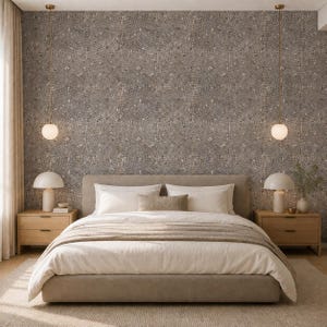May include: A bedroom featuring a beige upholstered bed with white bedding, two light wood nightstands, and two white mushroom-shaped table lamps. Two spherical pendant lights hang from the ceiling against a wall with a circular mosaic pattern.