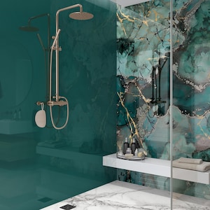 May include: A contemporary bathroom featuring teal and marble elements. A bronze shower fixture with a rain shower head is mounted on a teal wall. A white shelf holds toiletries and a towel. The shower wall has a marble design.