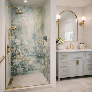 May include: A bathroom featuring a floral mural shower, gold fixtures, and a light blue vanity unit. The shower has a glass door and a built-in shelf. The vanity has a marble worktop and a gold-framed mirror.